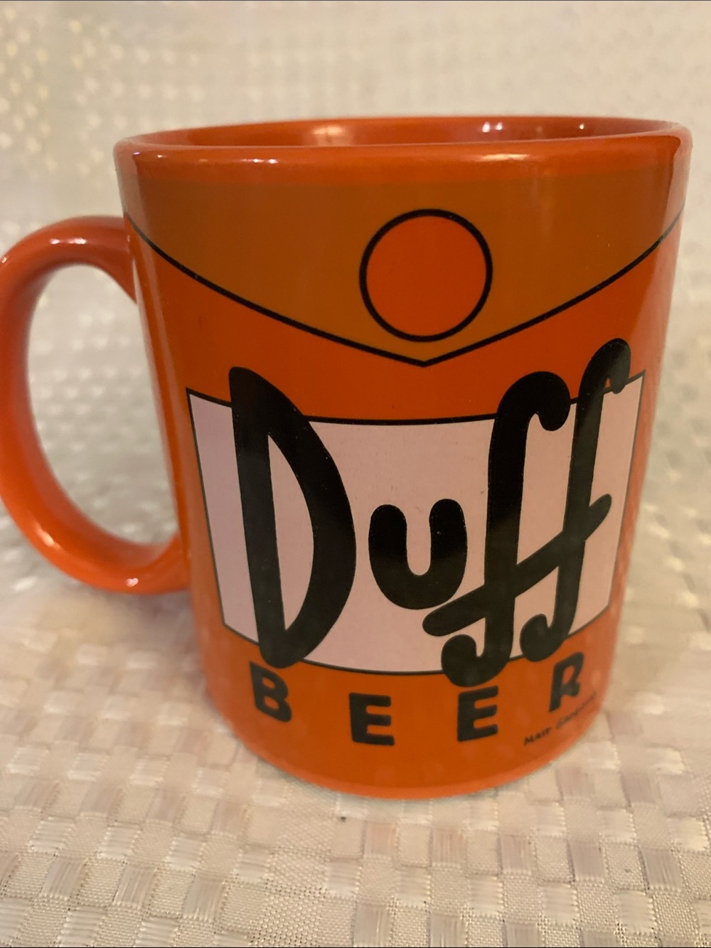 The Simpsons Orange Duff Beer Ceramic Mug, approximately 4 inches high. 2019.